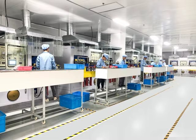 Cletus production team working on a cleanroom production line